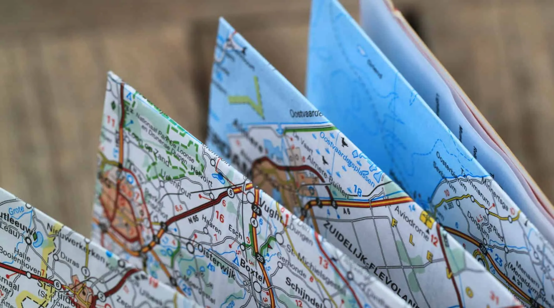 Several folded road maps showing roads and waterways