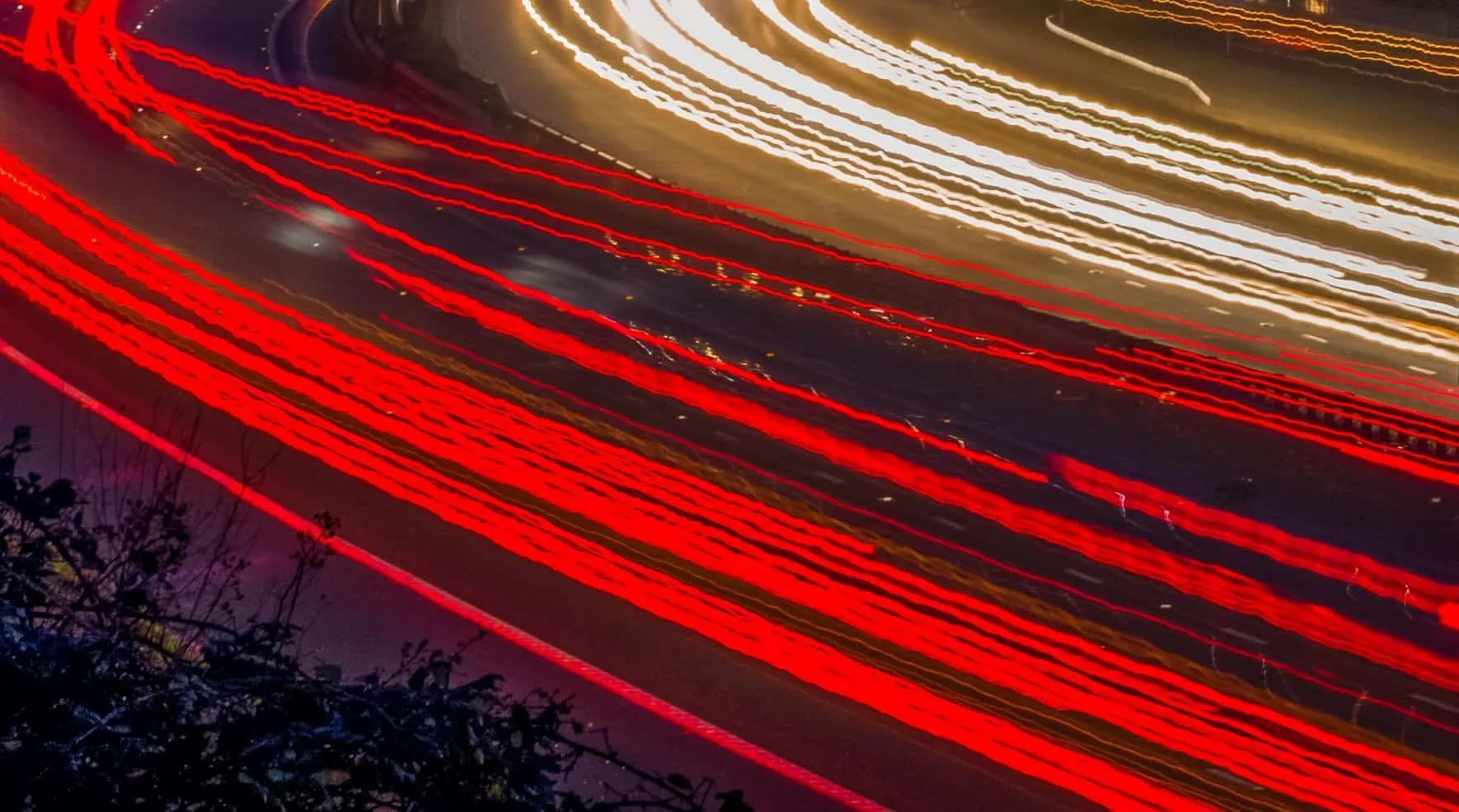 Red and white light trails of cars driving at night