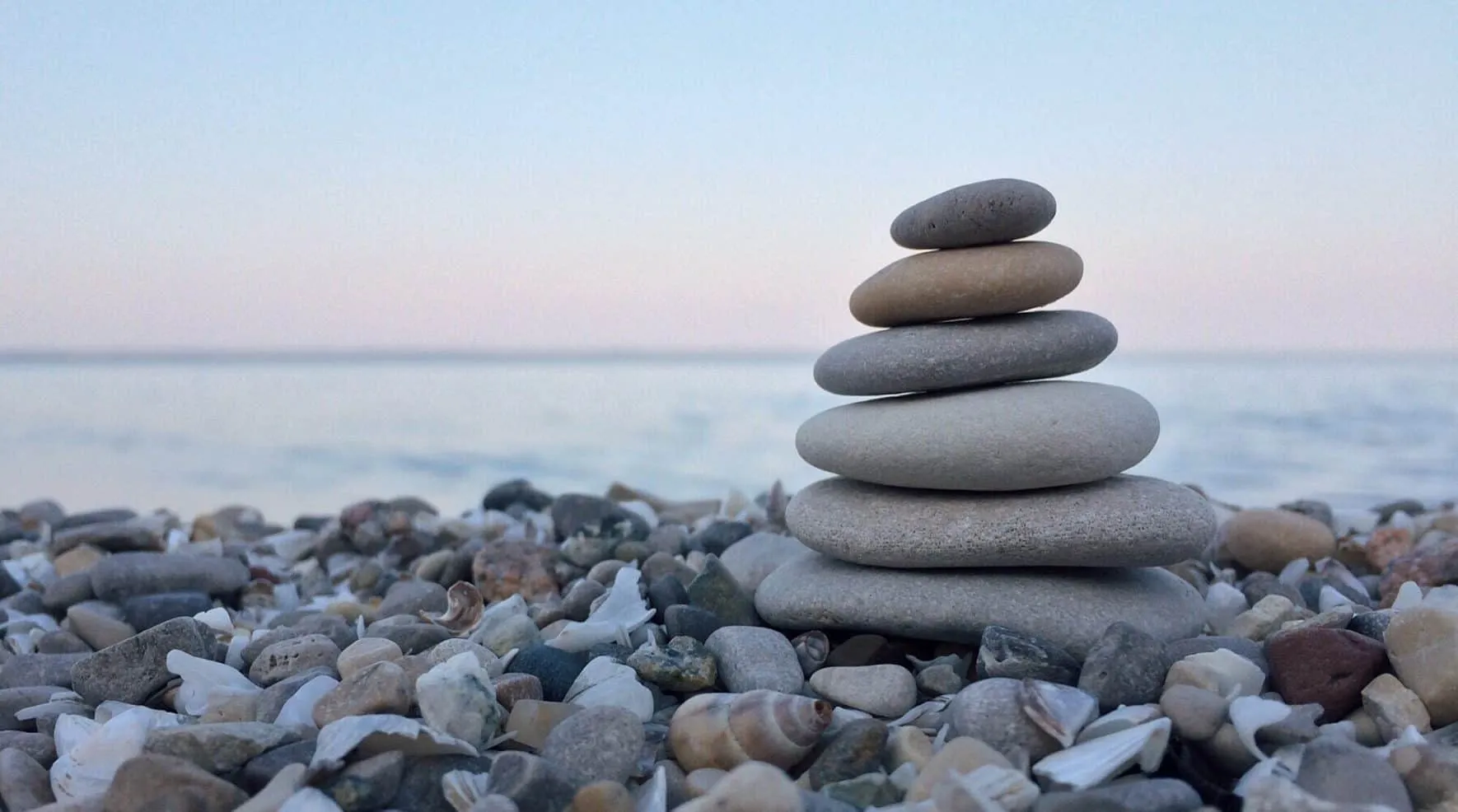 Tower of flat pebbles stacked on top of each other on a beach