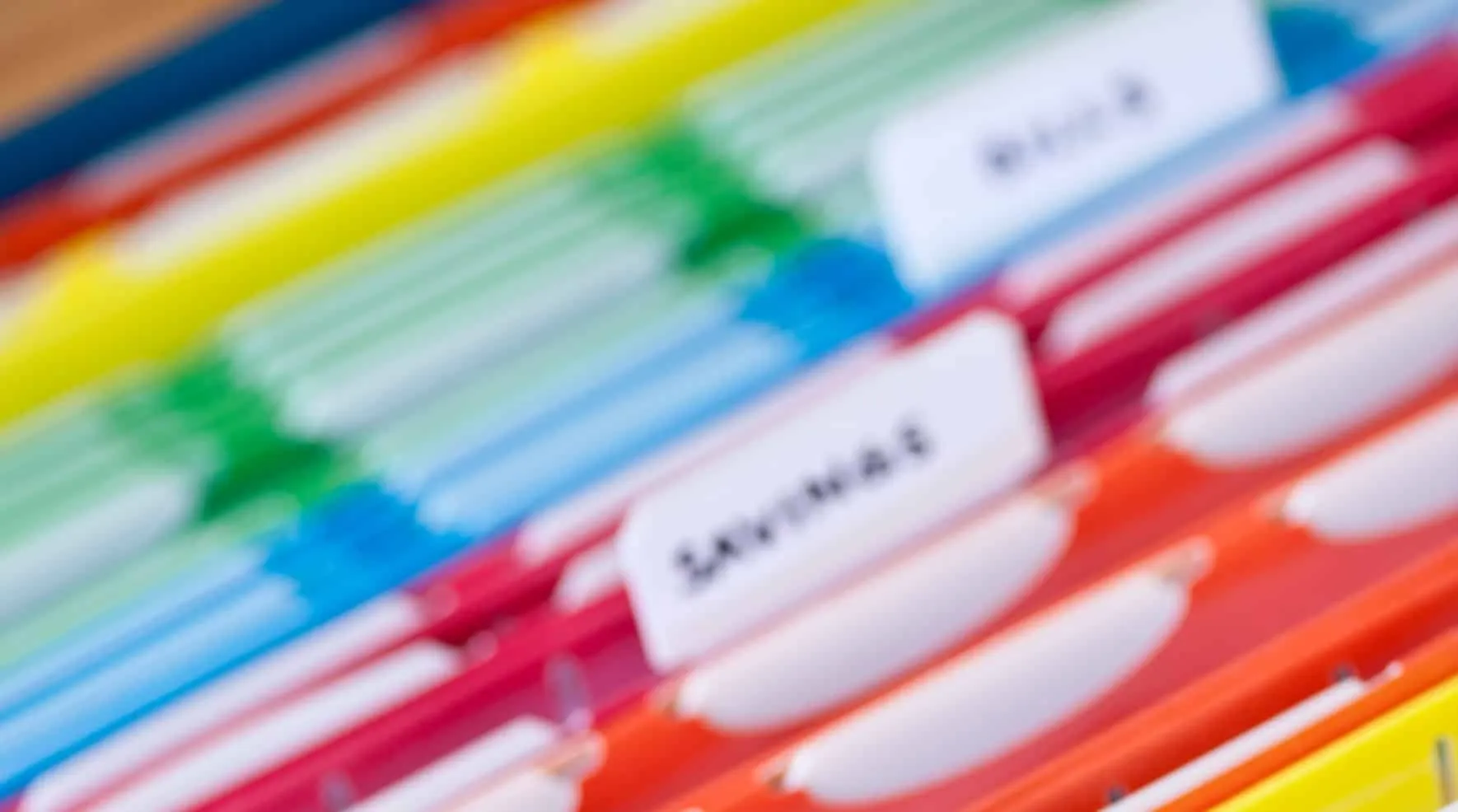 Colorful hanging files with labeled tabs
