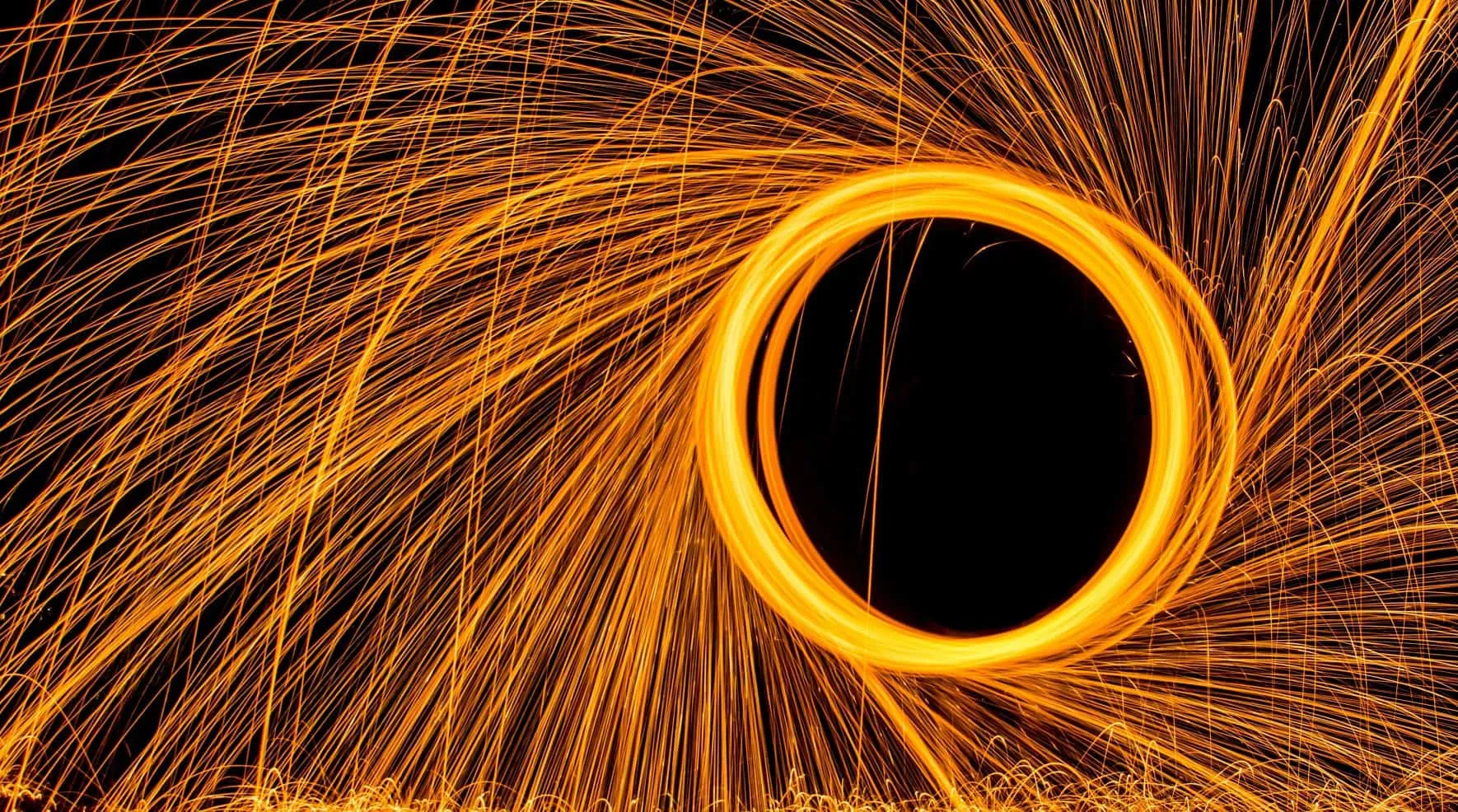 Circle of glowing sparks against a black background