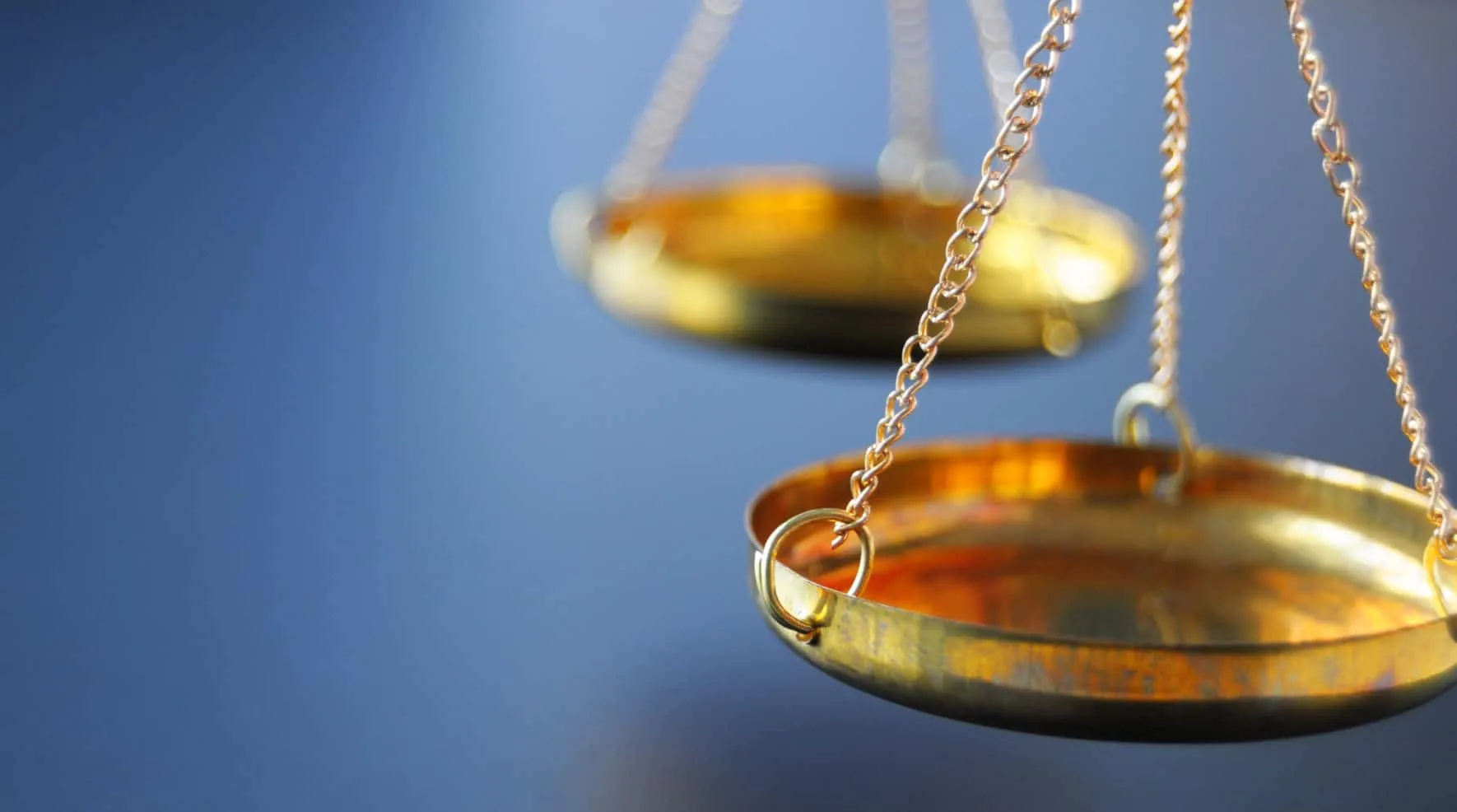 Two brass pans of a balance scale