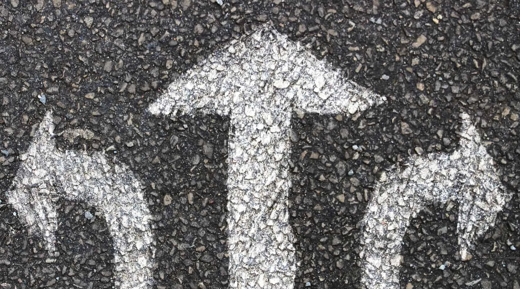 Road marking with arrows pointing left, straight ahead and right