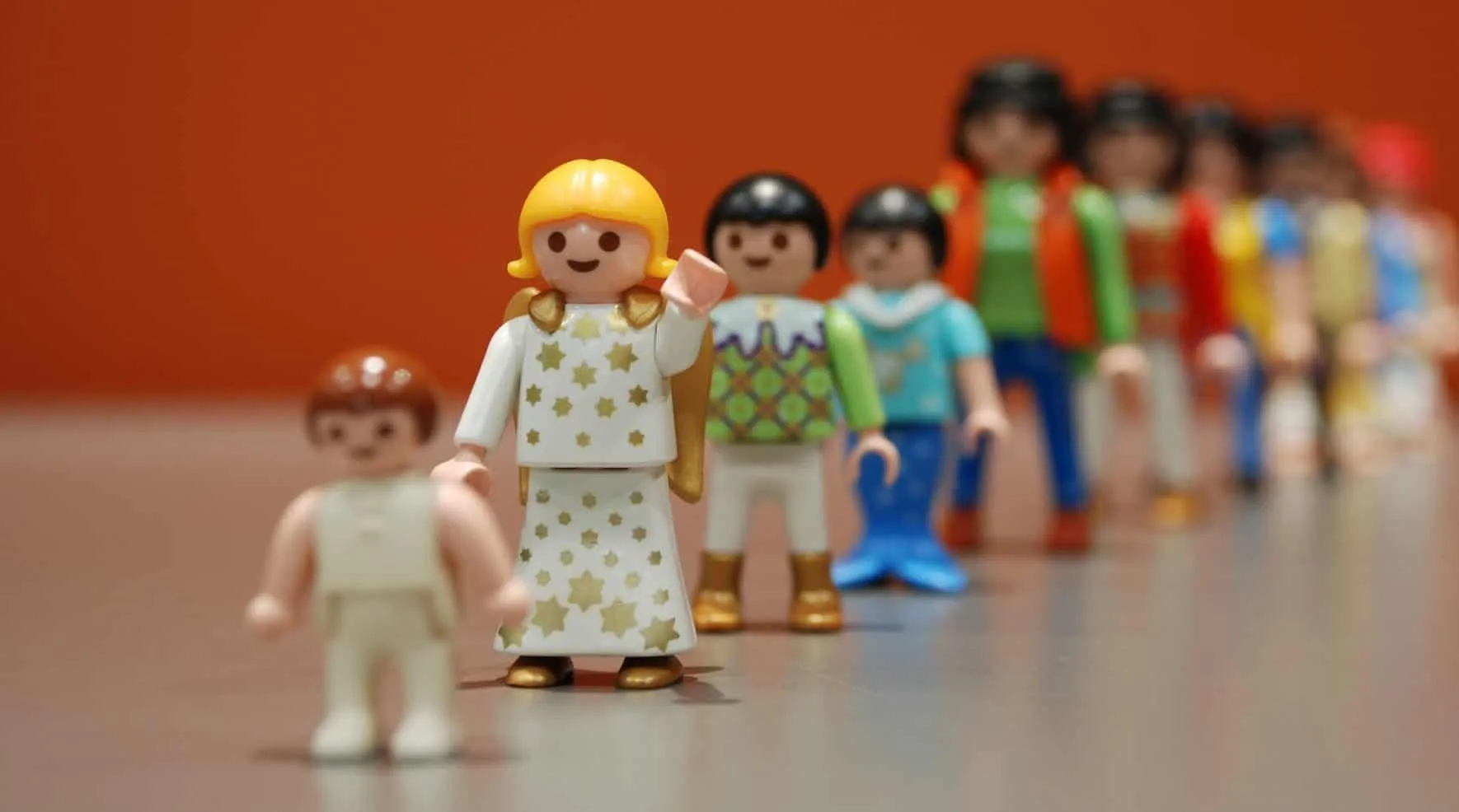 Toy figures standing one behind the other in a queue