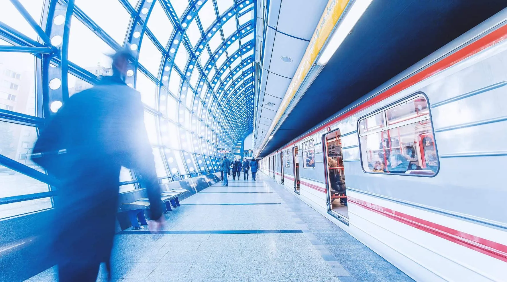 Subway station with an arriving train and waiting passengers